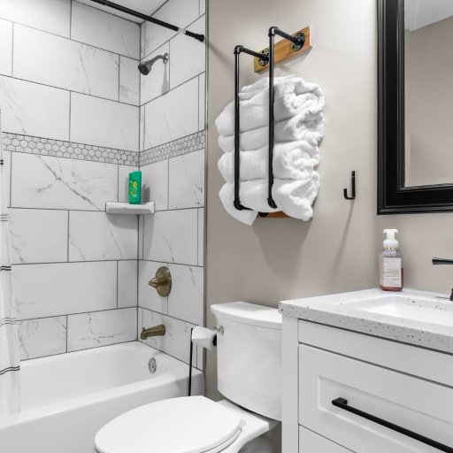 Full bath with tub/shower and marble-look tile