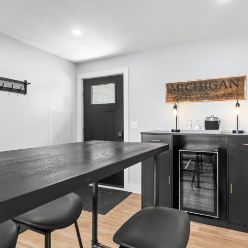 Bar with beverage fridge and high-top seating