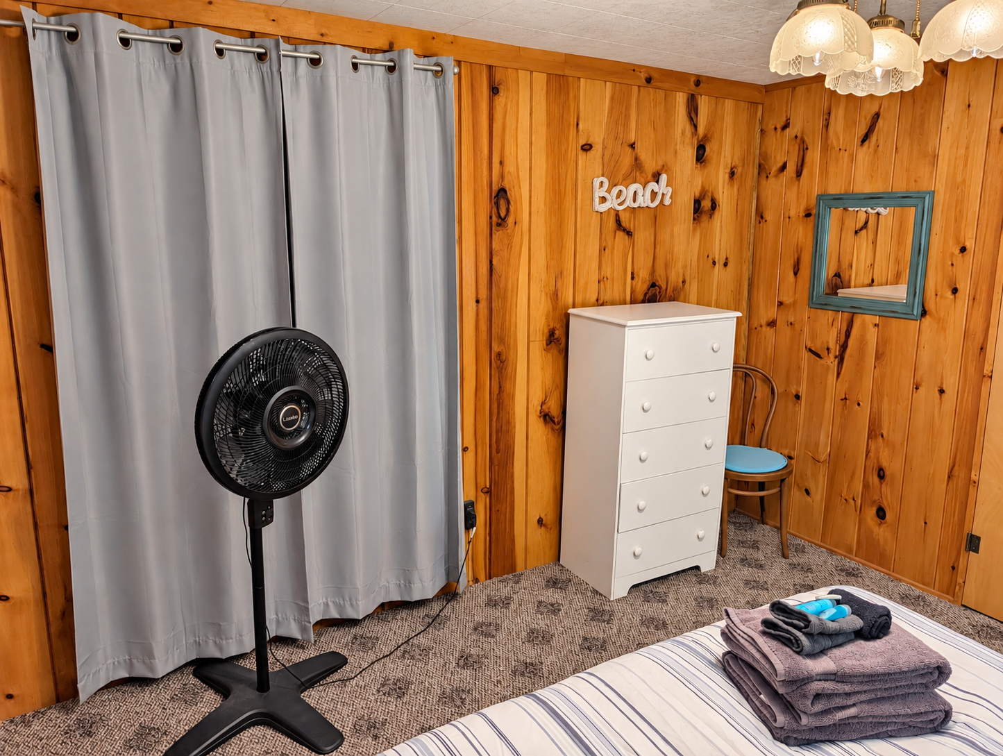 BEDROOM #1:   Features a queen-size bed, nightstands, lamp, dresser, closet, and chair.
