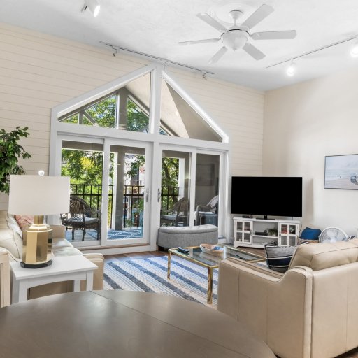Dining table, living room, and the vaulted window wall in one open space.