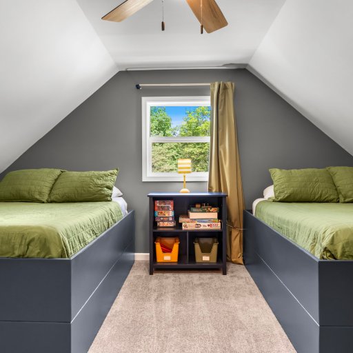 Upstairs room with two full beds and the game library