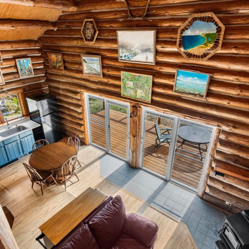 Open kitchen, dining and living space inside the log walls