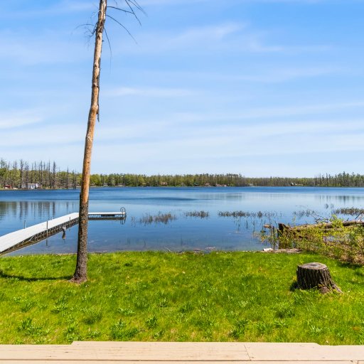 Grassy yard running down to the shoreline and dock