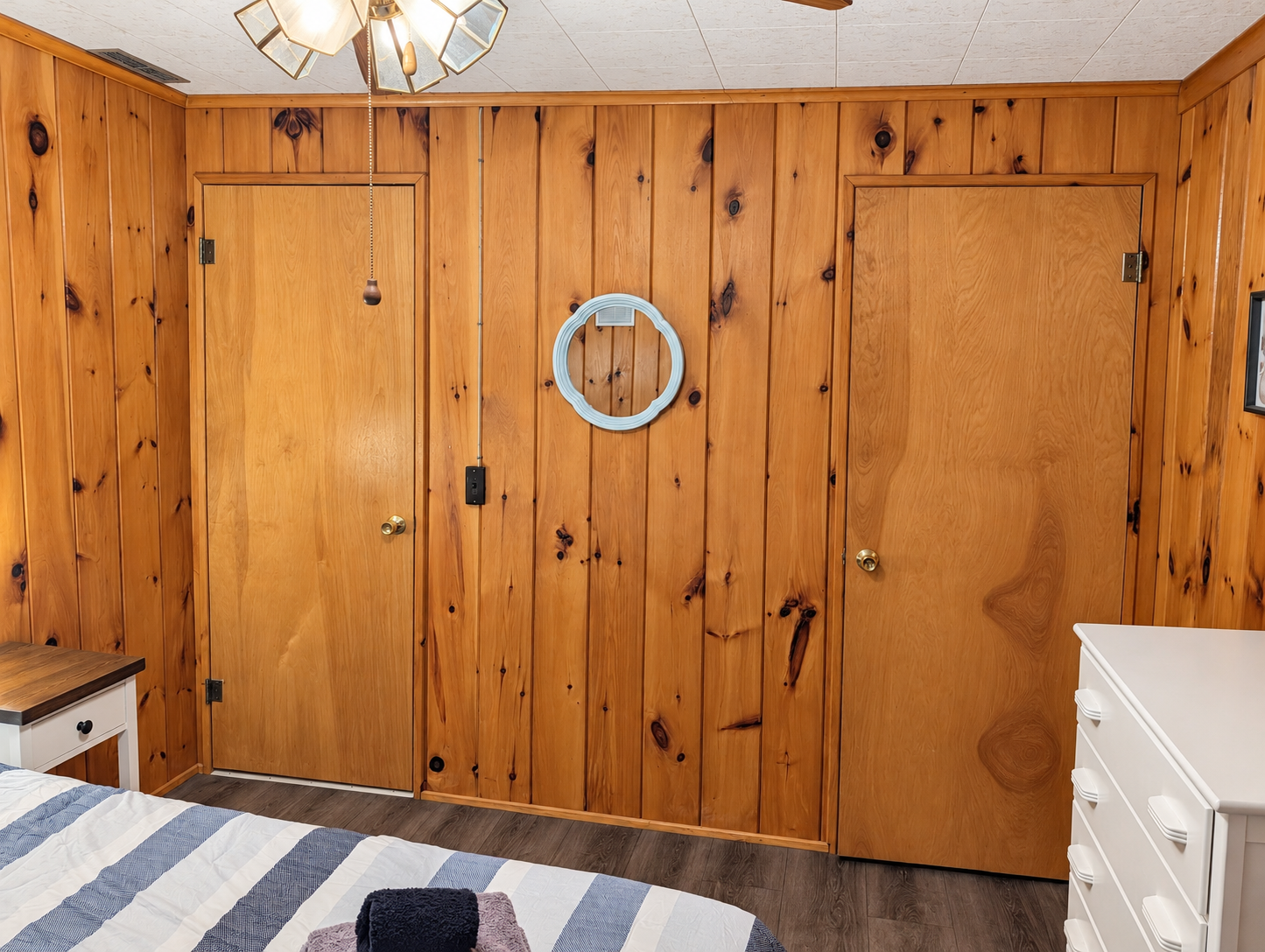 BEDROOM #2:   Features a queen-size bed, nightstands, lamp, dresser, closet, and chair.