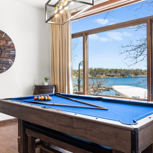 Play pool steps from the lake-view window — game nights with Round Lake glowing through the glass.