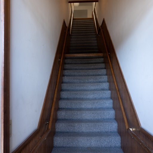 The private staircase up to the loft — one flight from your Bridge Street door, with handrails on both sides