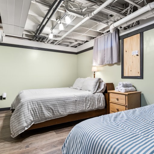 Lower-level bedroom with a full and a twin