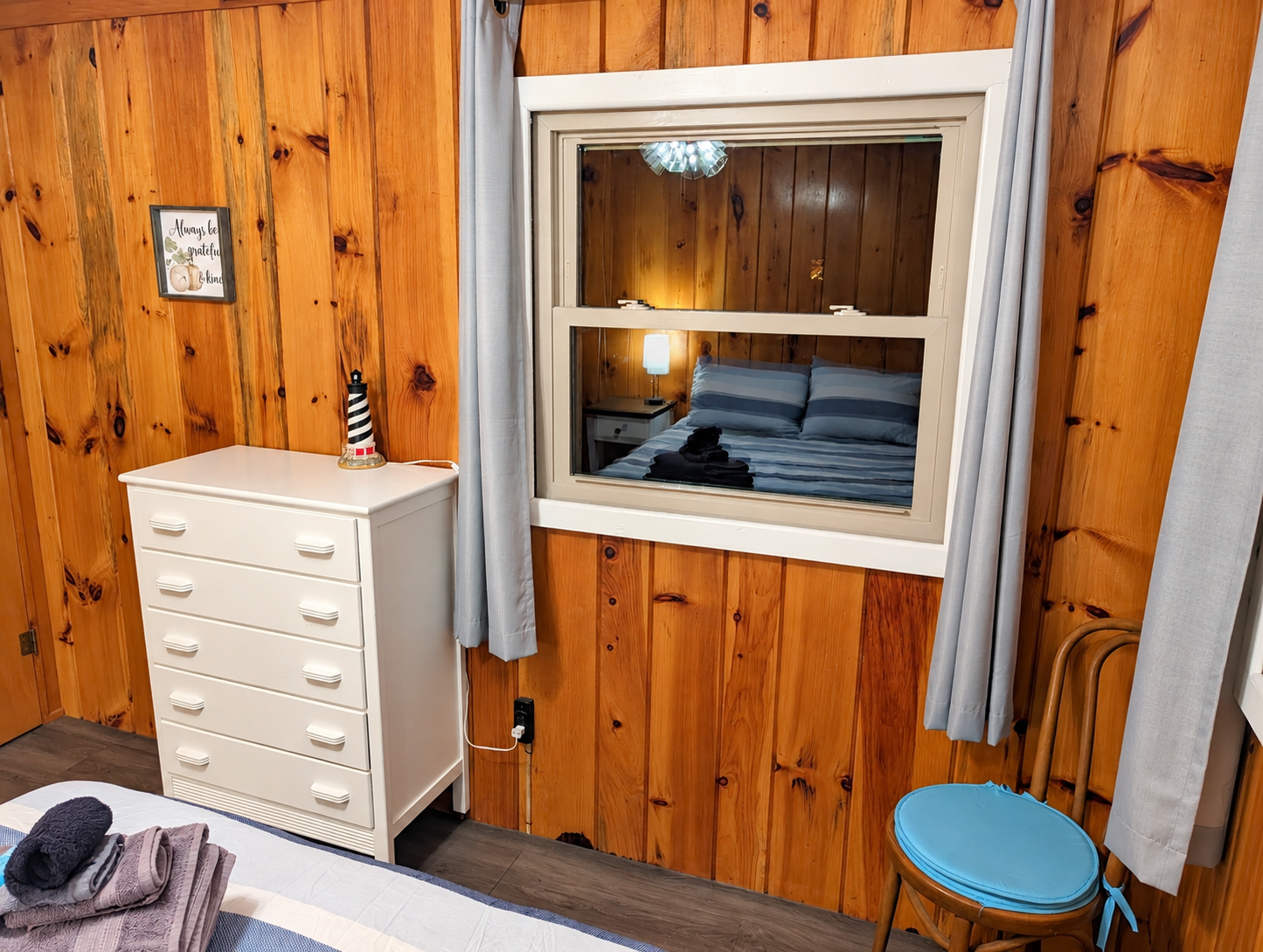 BEDROOM #2:   Features a queen-size bed, nightstands, lamp, dresser, closet, and chair.