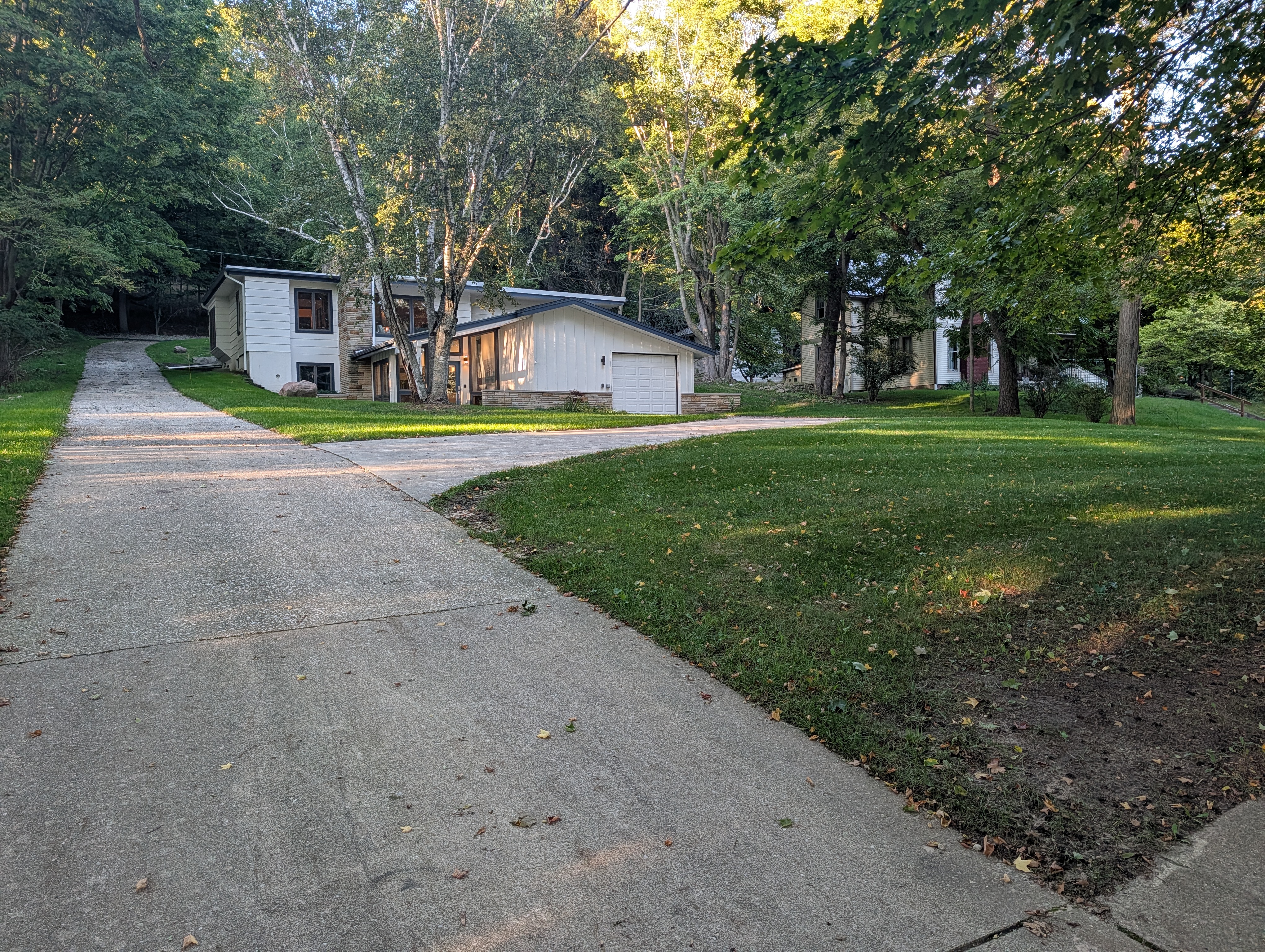 EXTERIOR:  The large front yard and private driveway