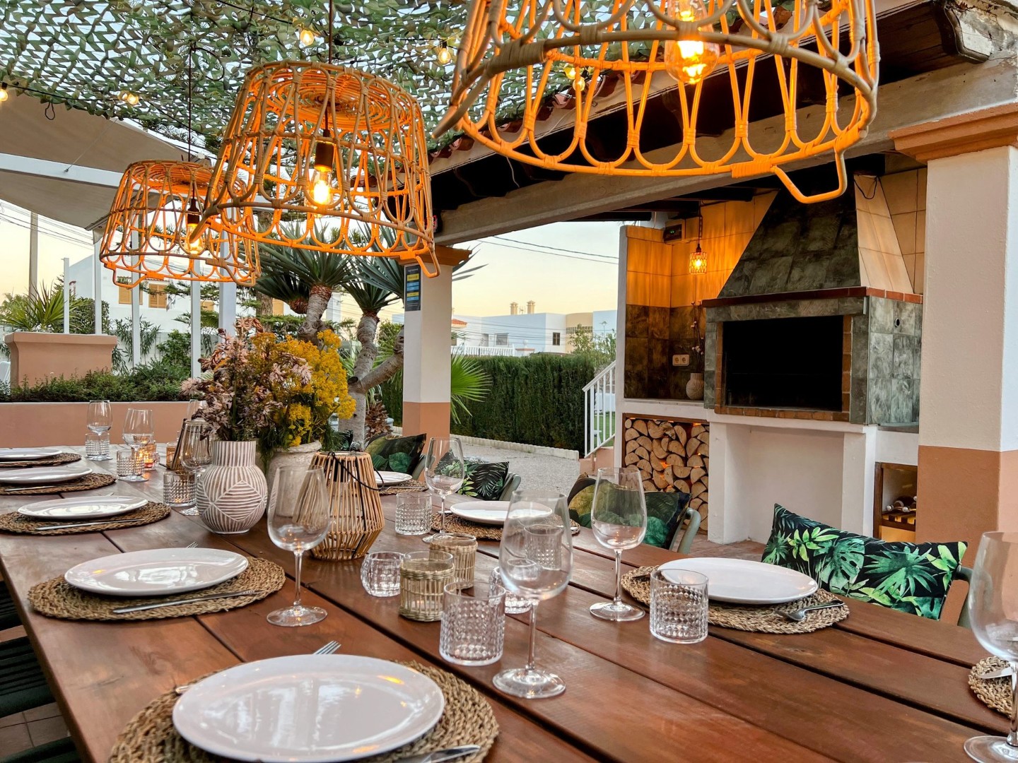 Dinner under the lights. Covered terrace with an outdoor barbecue and long dining table for warm evenings, Villa Kiku.