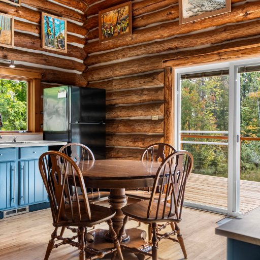 Dining table for four beside the deck doors