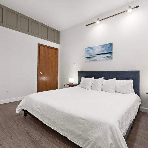 Bedroom 3: King bed with coastal art — Northern Michigan calm carries into the sleeping quarters.