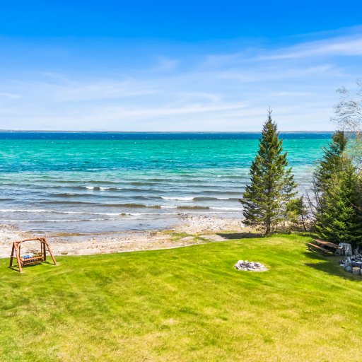 Shared firepit and picnic table on the lawn - Lake Huron a few steps past it.