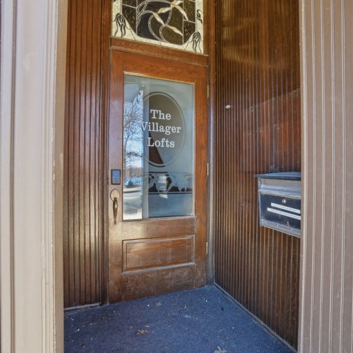 Private loft entry on Bridge Street — your own door, not a shared lobby, with Villager Pub right downstairs.
