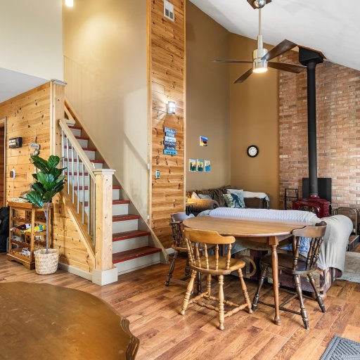 Great room with the wood stove and stairs to the upper bedrooms