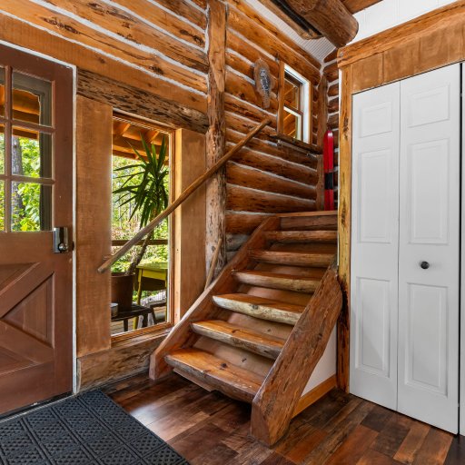 Entry with log stairs up to the loft