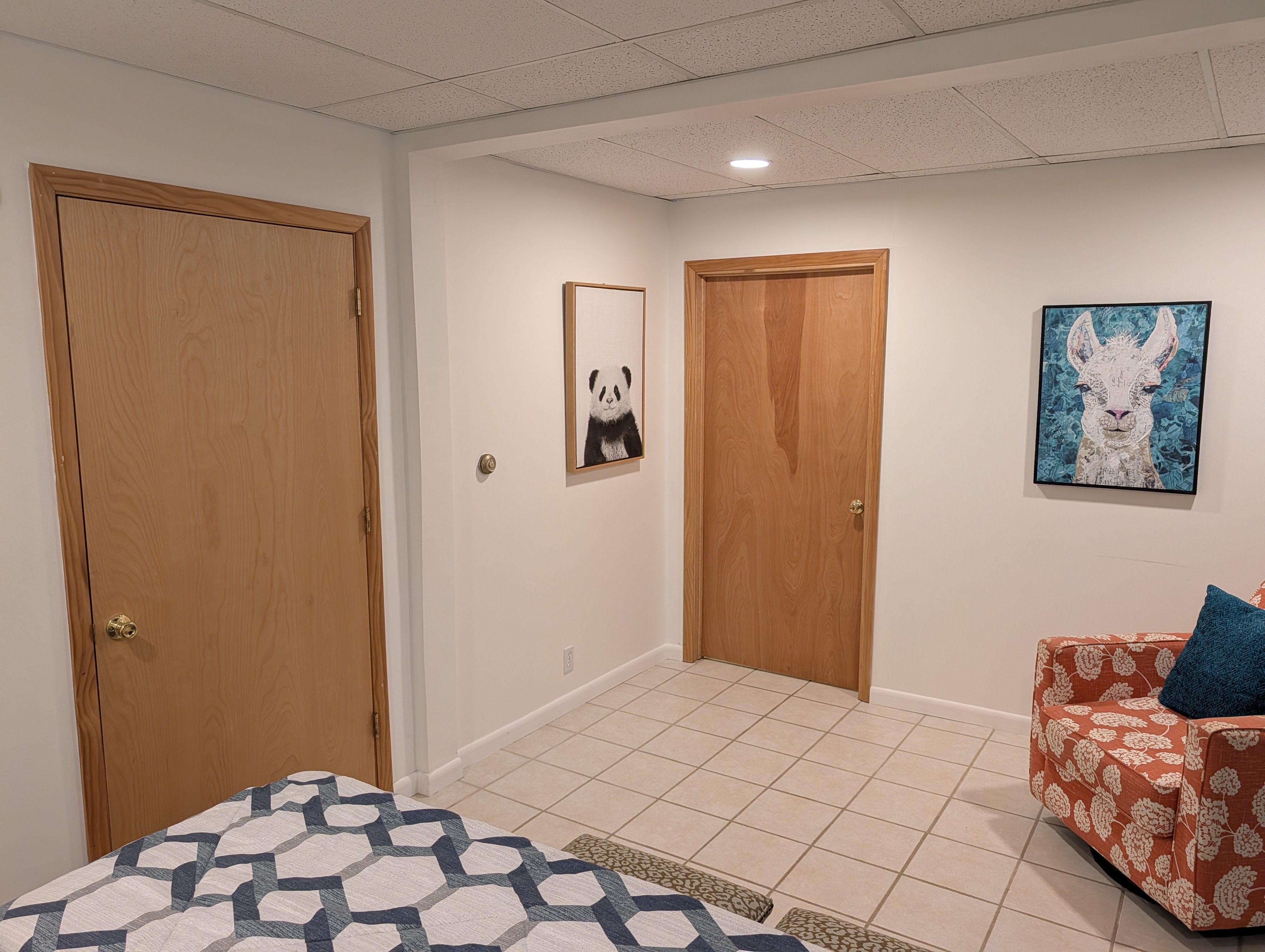 BEDROOM #1 (FIRST FLOOR):  Features a queen-size bed, nightstands, lamps, chair, dresser, and closet.