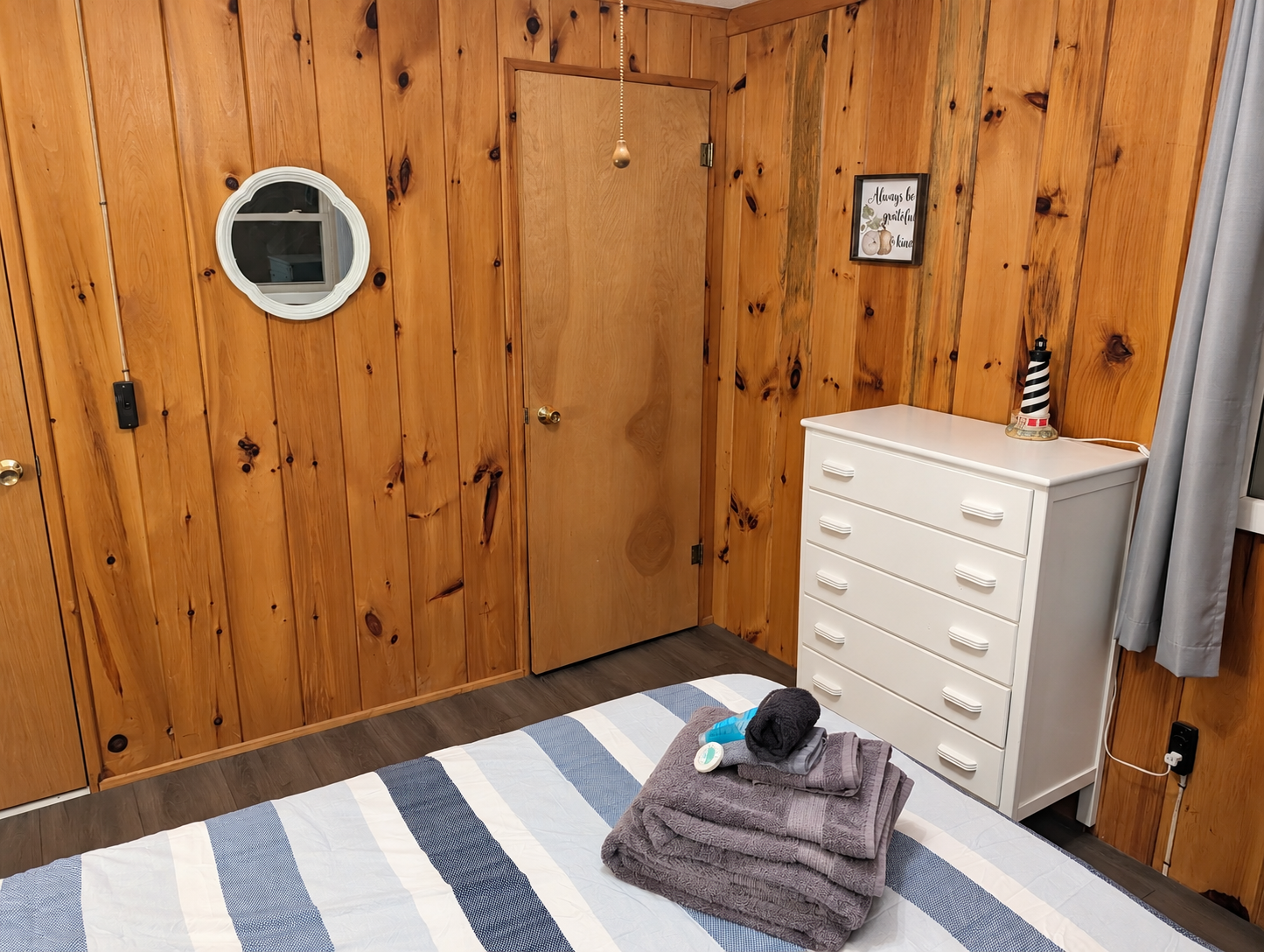 BEDROOM #2:   Features a queen-size bed, nightstands, lamp, dresser, closet, and chair.