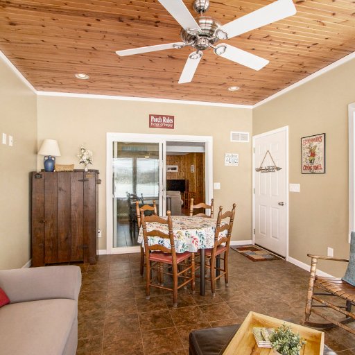 Sunroom with dining table for four and windows on three sides