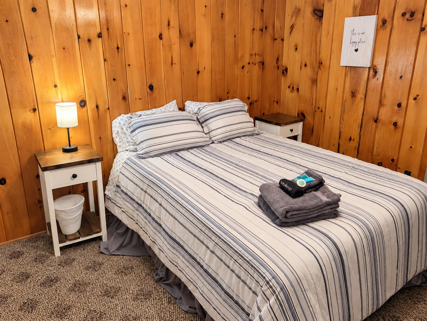 BEDROOM #1:   Features a queen-size bed, nightstands, lamp, dresser, closet, and chair.
