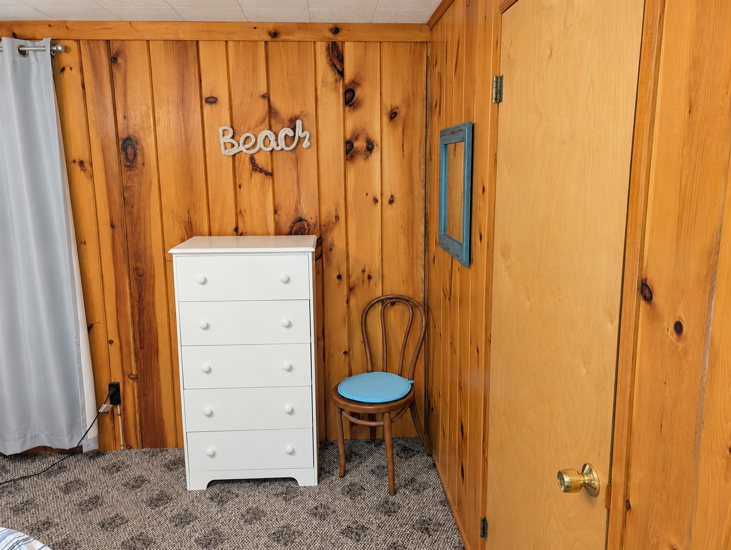 BEDROOM #1:   Features a queen-size bed, nightstands, lamp, dresser, closet, and chair.