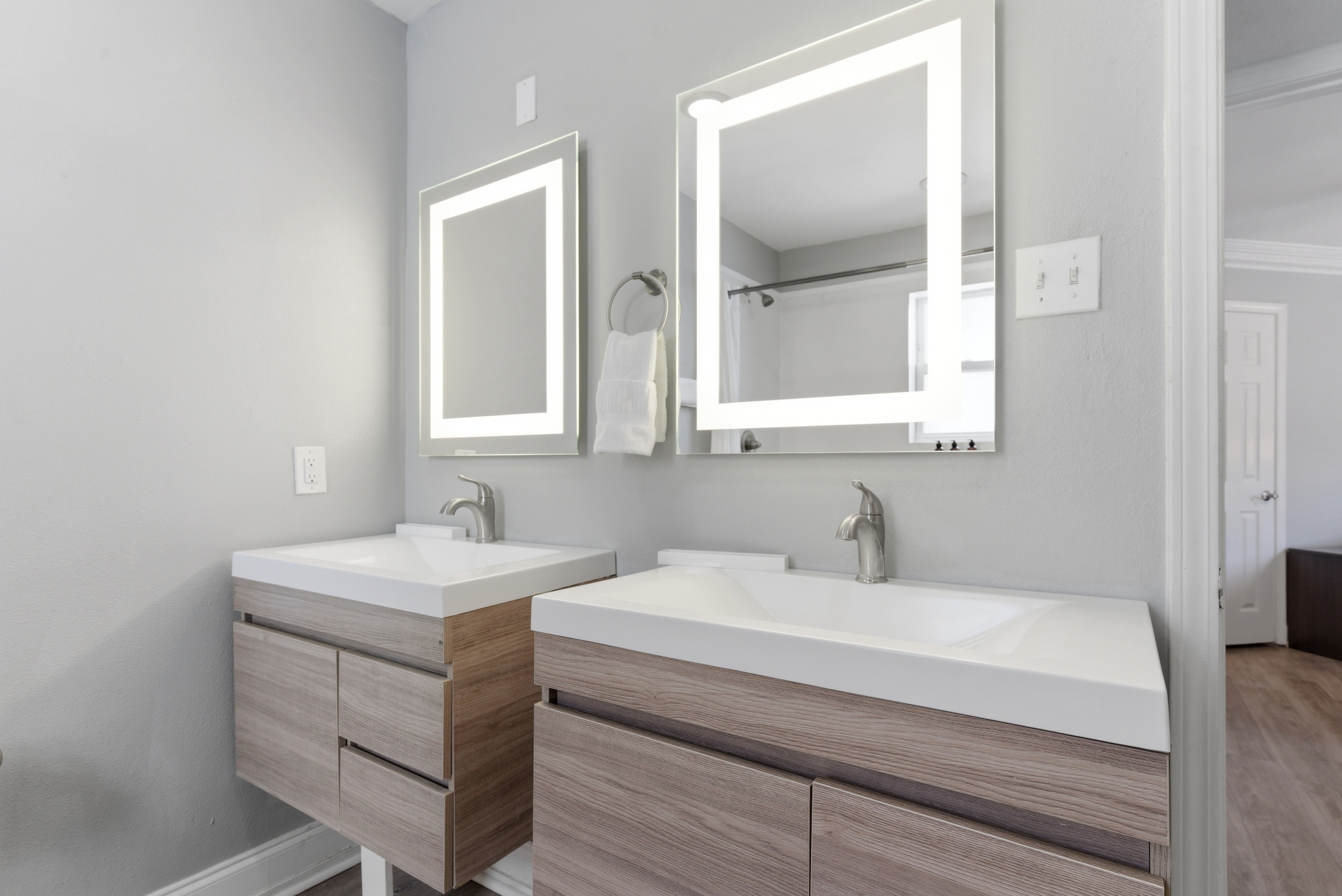 Bright bathroom with dual sink setup and essentials to refresh & unwind. Gives you extra space to get ready with ease