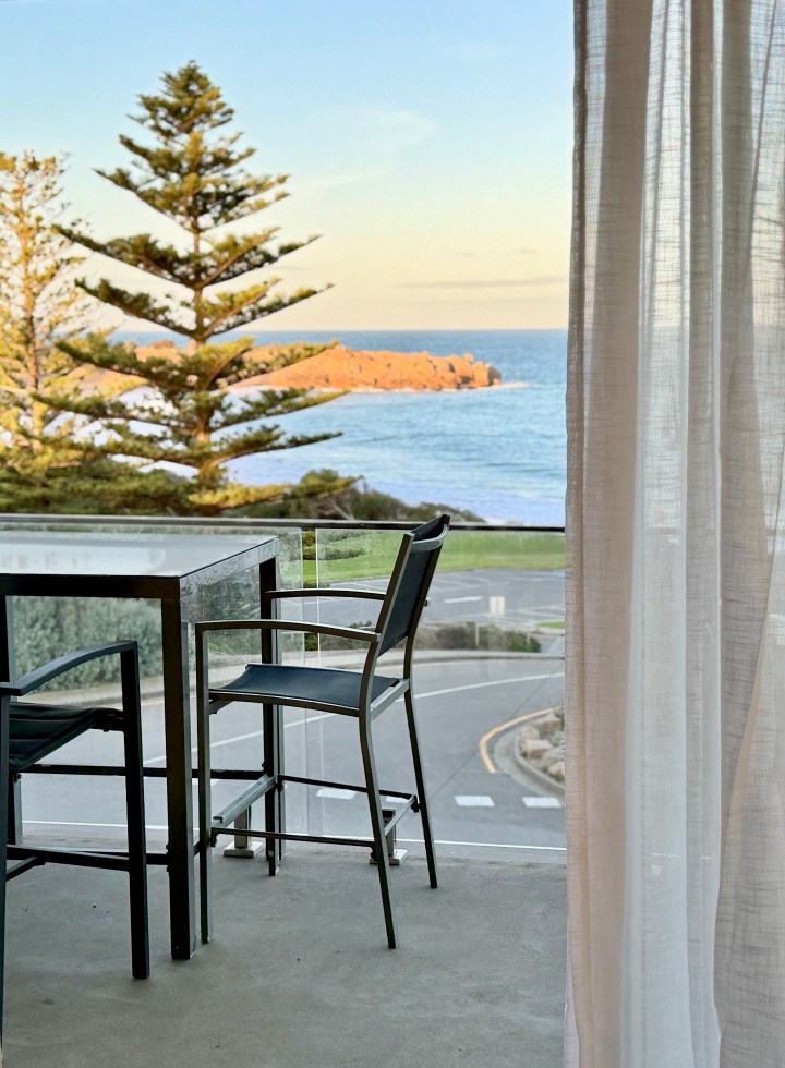 Spacious Balcony. Bar-height outdoor dining with 4 chairs. Glass balustrades for enhanced ocean vistas. Equipped with a brand-new Baby Weber Q BBQ with hood.