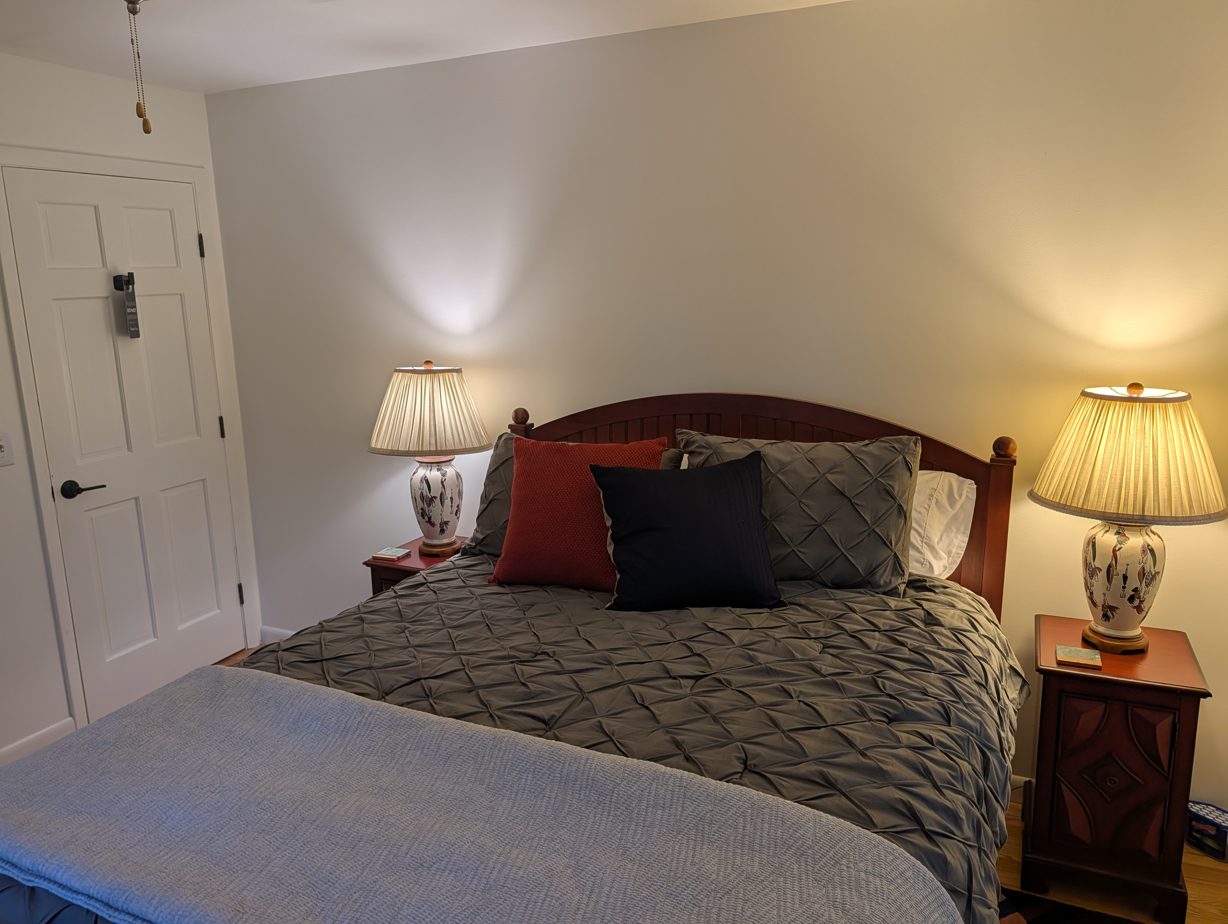 BEDROOM #2 (SECOND FLOOR):  Features a queen-size bed, nightstands, lamps, ceiling fan, dresser, mirror, and closet.