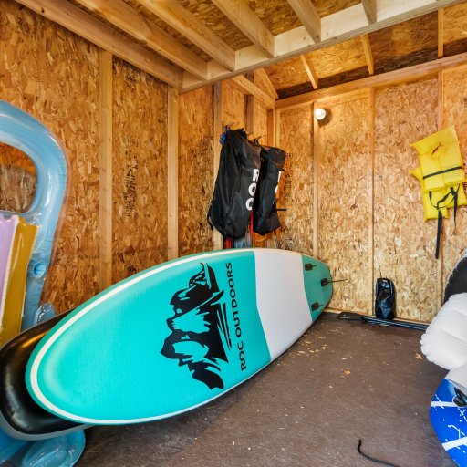 Paddleboards and lake gear on site in the shed