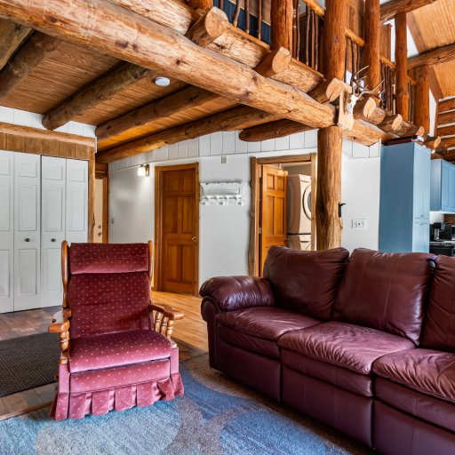 Living room with recliner and the stairs to the loft