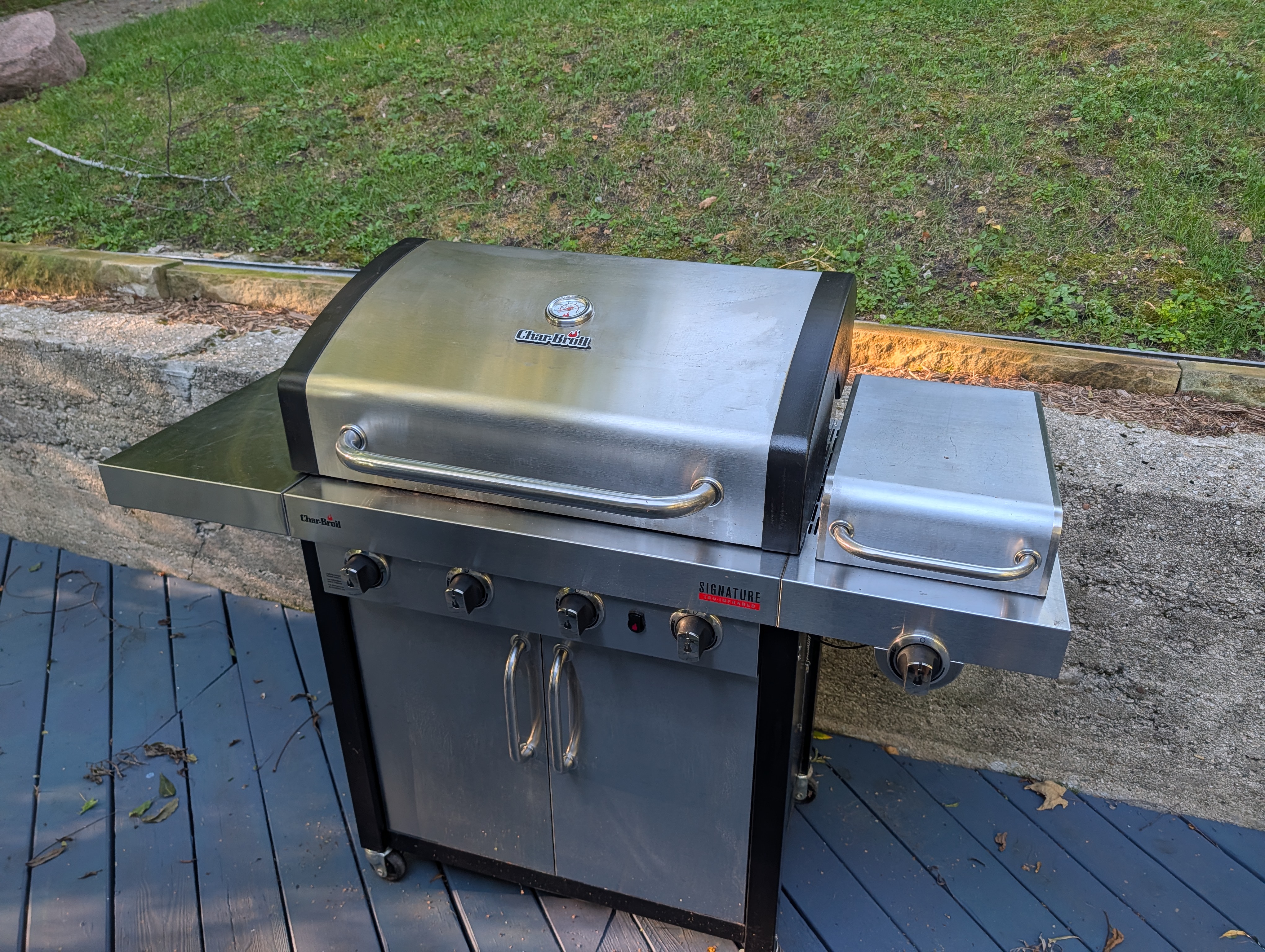 EXTERIOR:  The gas grill on the backyard deck.