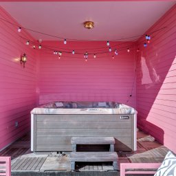Soak in the tub under a wash of pink neon light — pure indulgence after a long day out.