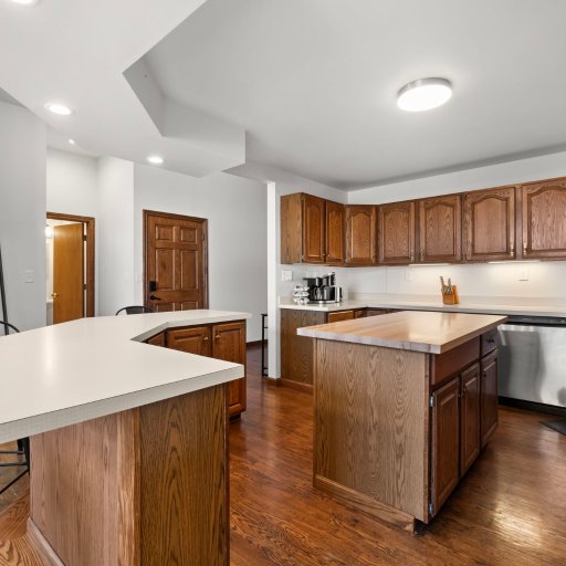 Full kitchen with bar seating for six — center island, dishwasher, and dedicated coffee station.