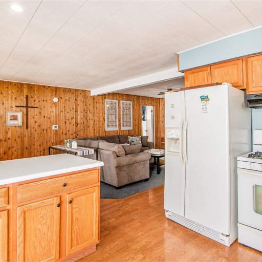 Kitchen with gas range and full-size fridge, open to the living room