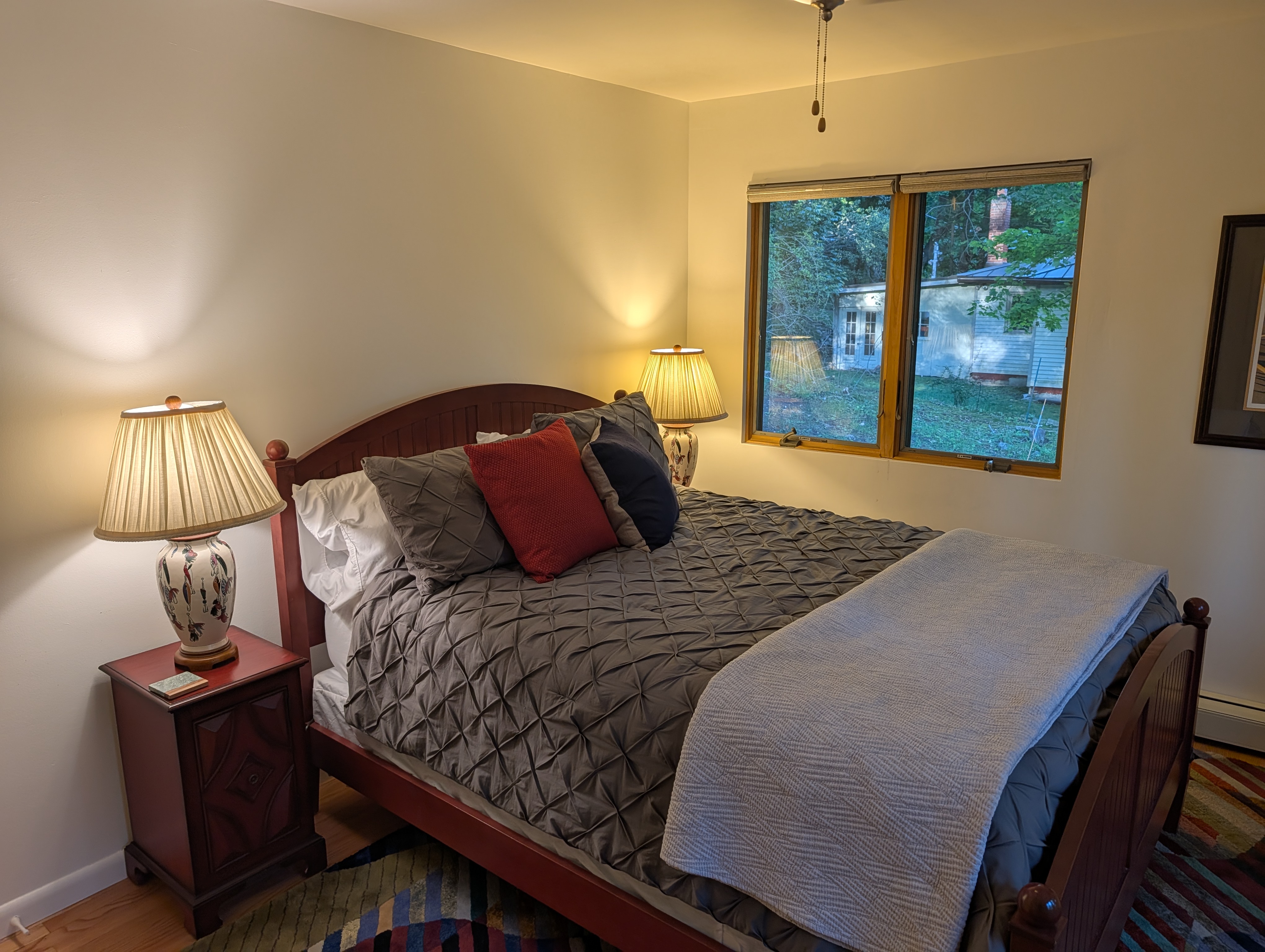 BEDROOM #2 (SECOND FLOOR):  Features a queen-size bed, nightstands, lamps, ceiling fan, dresser, mirror, and closet.