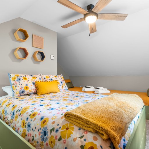 Full bed under the eaves with honeycomb shelves