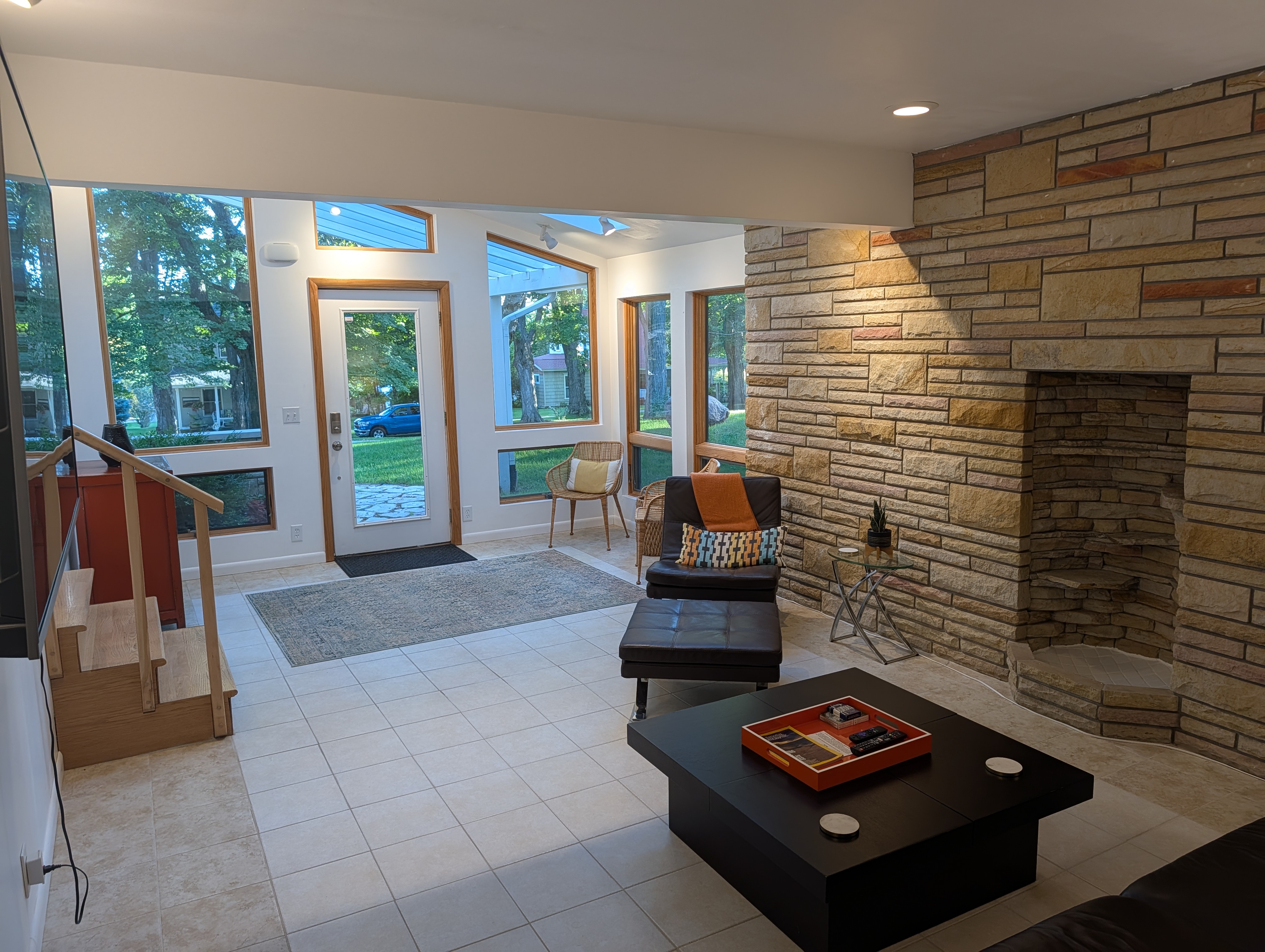 LIVING ROOM #1 (FIRST FLOOR):  Features a sofa, chairs, and large screen televison.