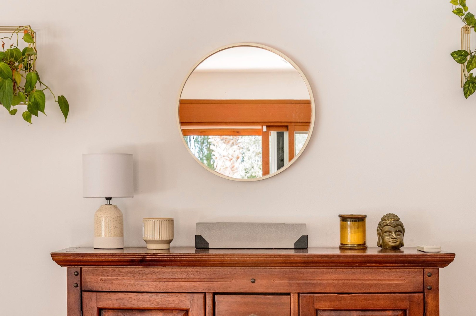 Styled sideboard with round mirror in the dining area, Villa Mika, Ibiza.
