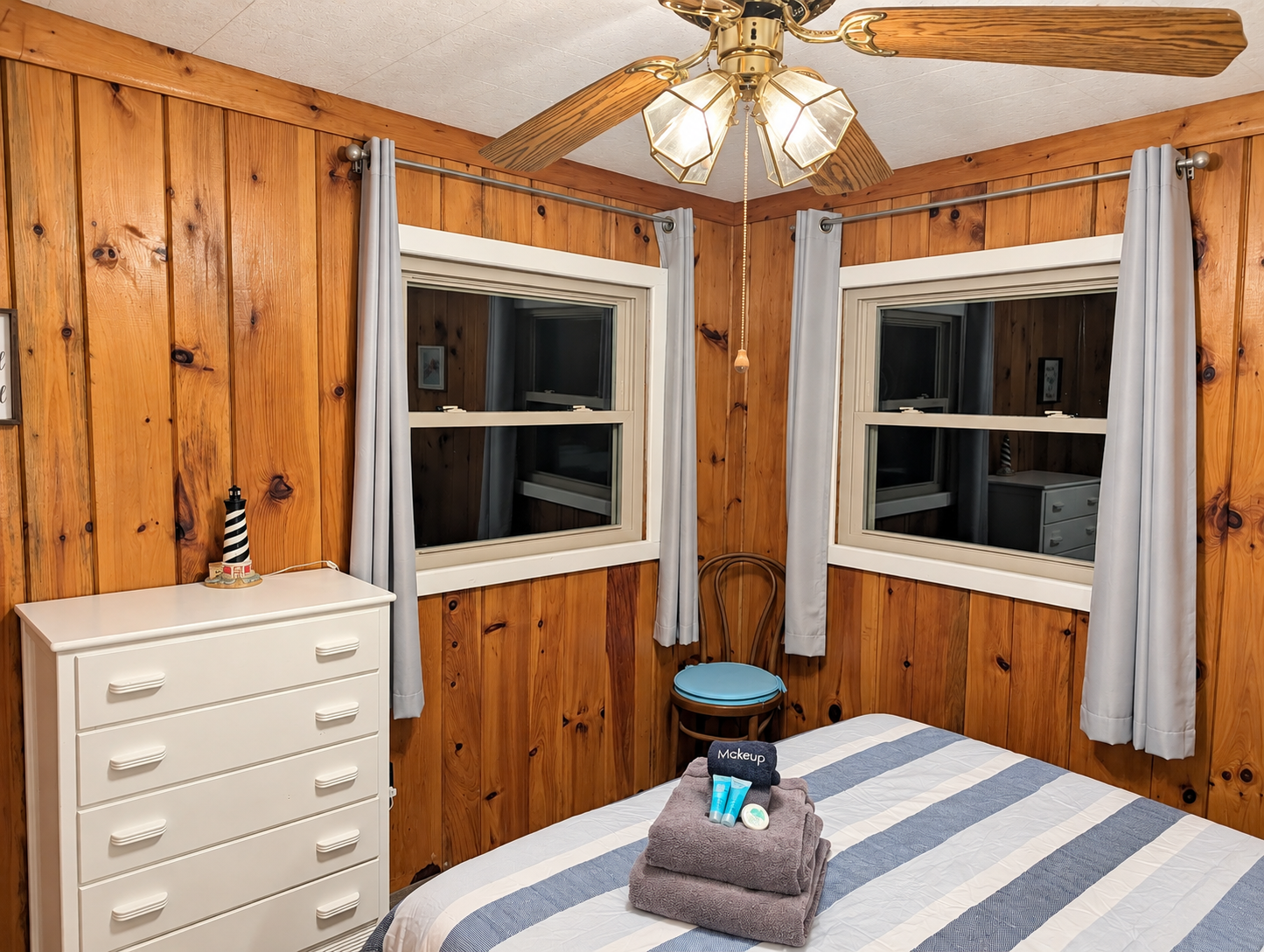 BEDROOM #2:   Features a queen-size bed, nightstands, lamp, dresser, closet, and chair.