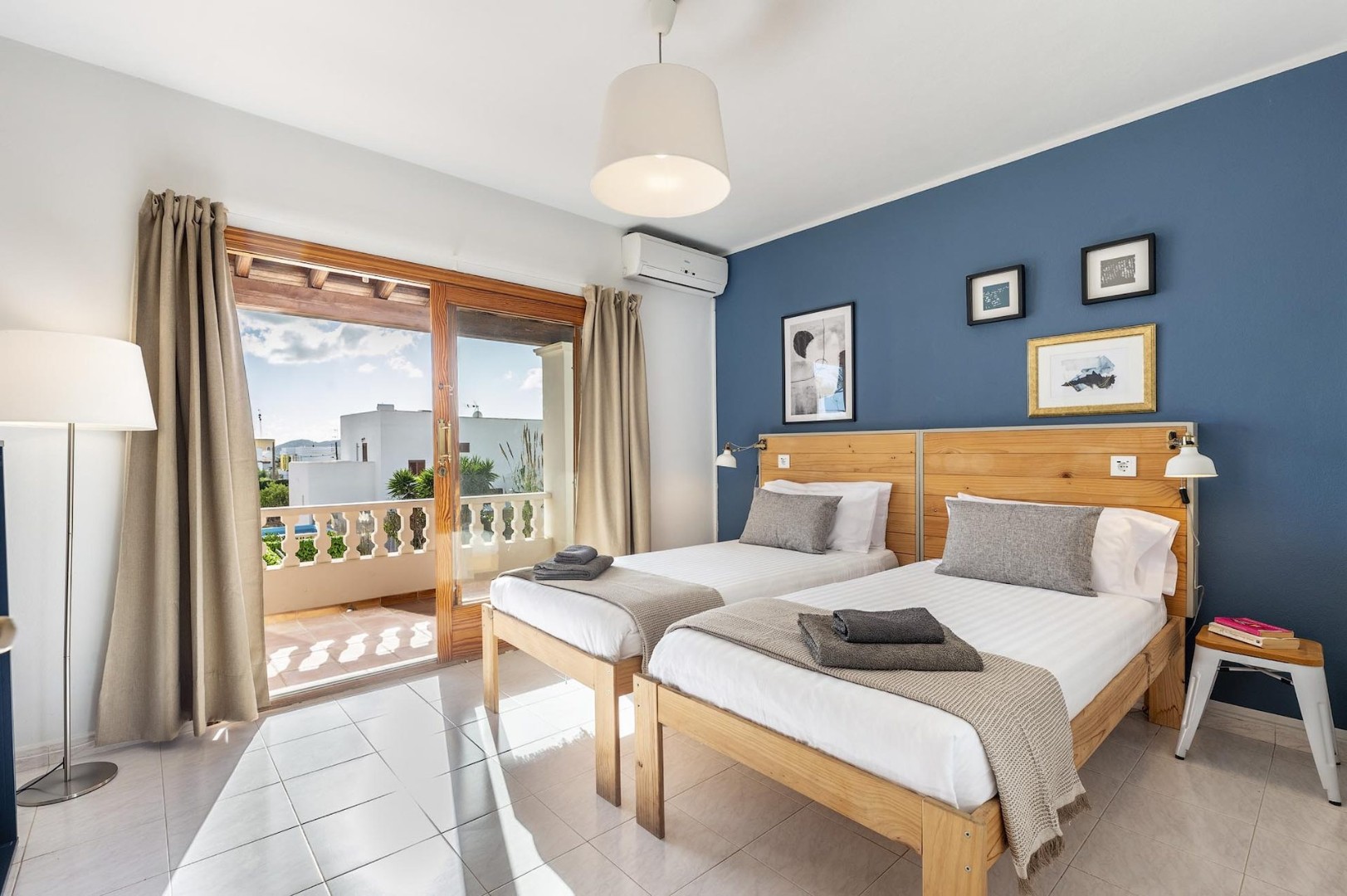 Bedroom with a blue feature wall and its own terrace access, Villa Kiku, Ibiza.