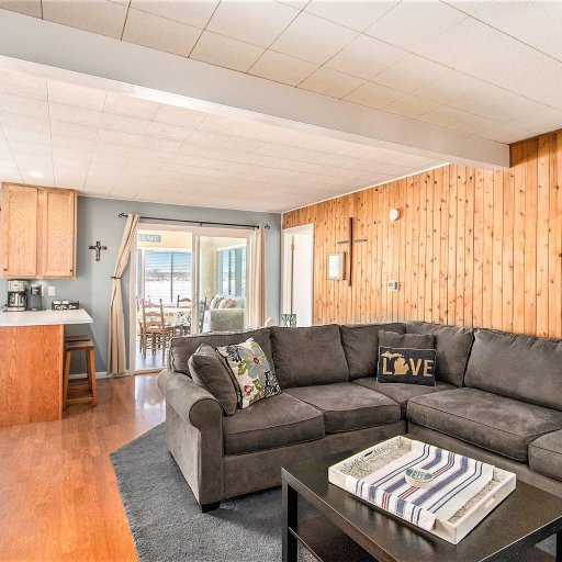 Living room sectional with the coffee bar and sunroom beyond