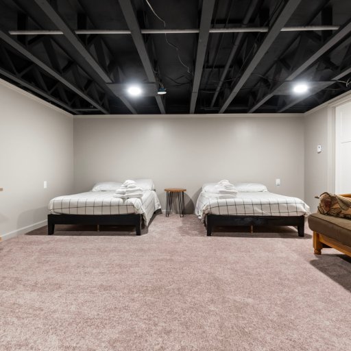 The basement Crew Room — two full beds, futon, smart TV and game table