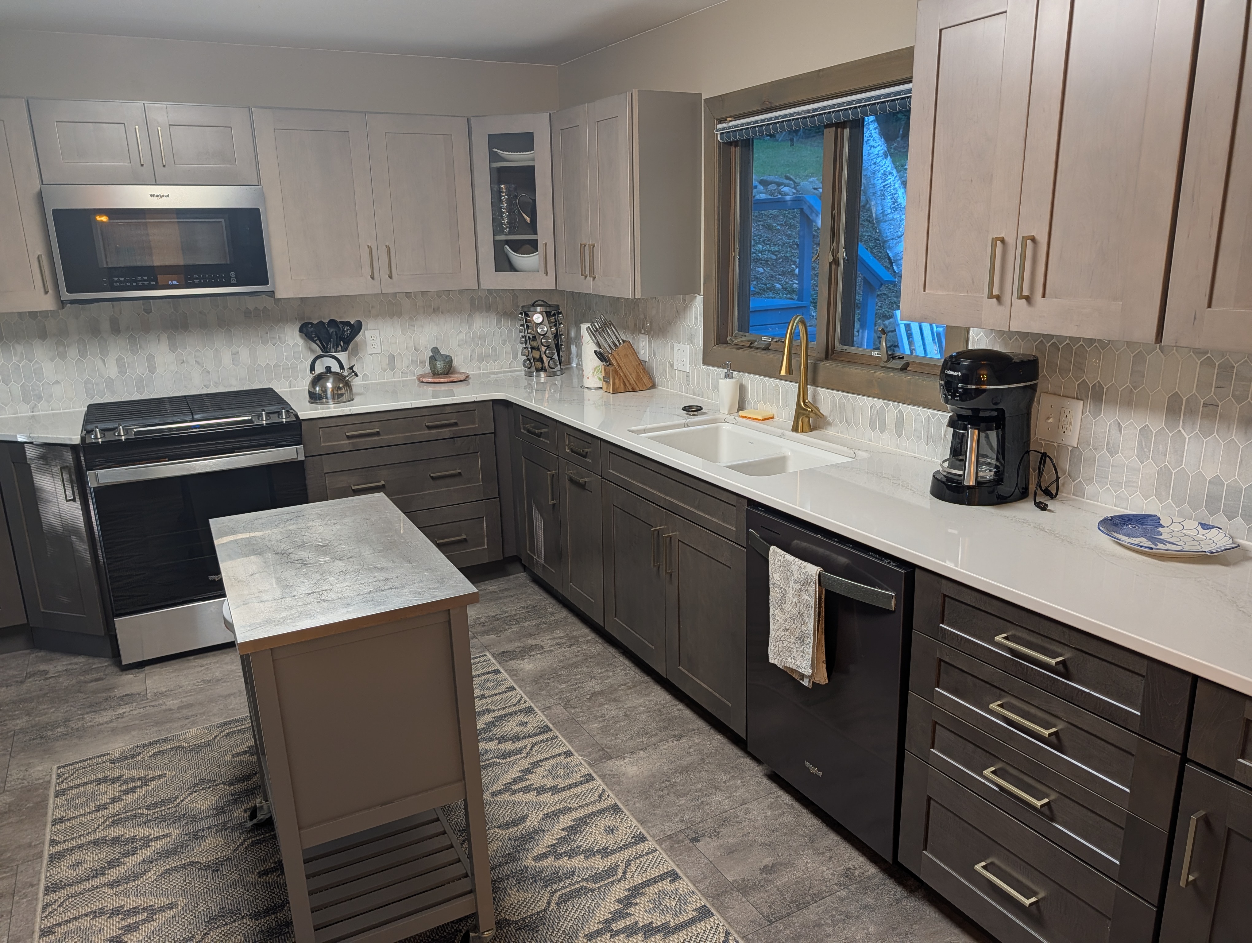 KITCHEN (SECOND FLOOR):  Large modern kitchen with a portal island and all appliances including a dishwasher and microwave.