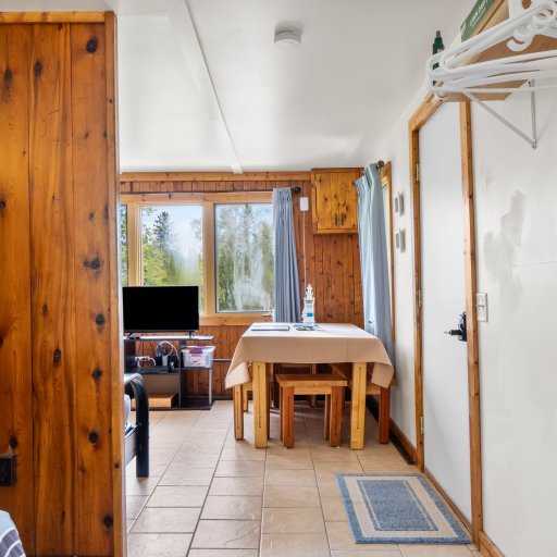 Eat-in dining for the group, with a TV and treetop views.