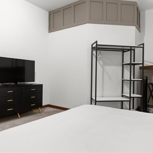 Bedroom 2 with smart TV, full dresser, and closet — guests unpack and stay, not luggage-in-the-corner.