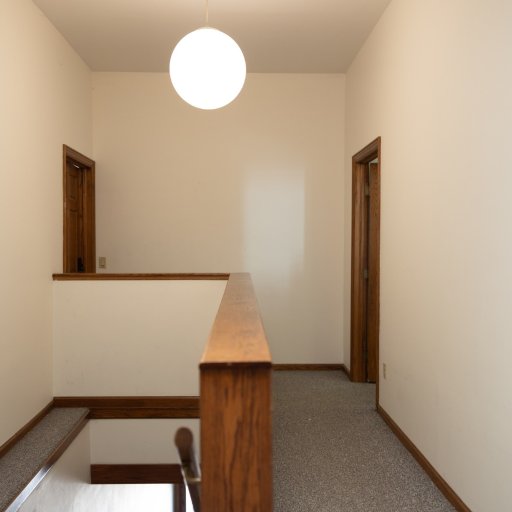Upstairs landing at the top of the stairs — opens to the loft's living space and bedroom wing