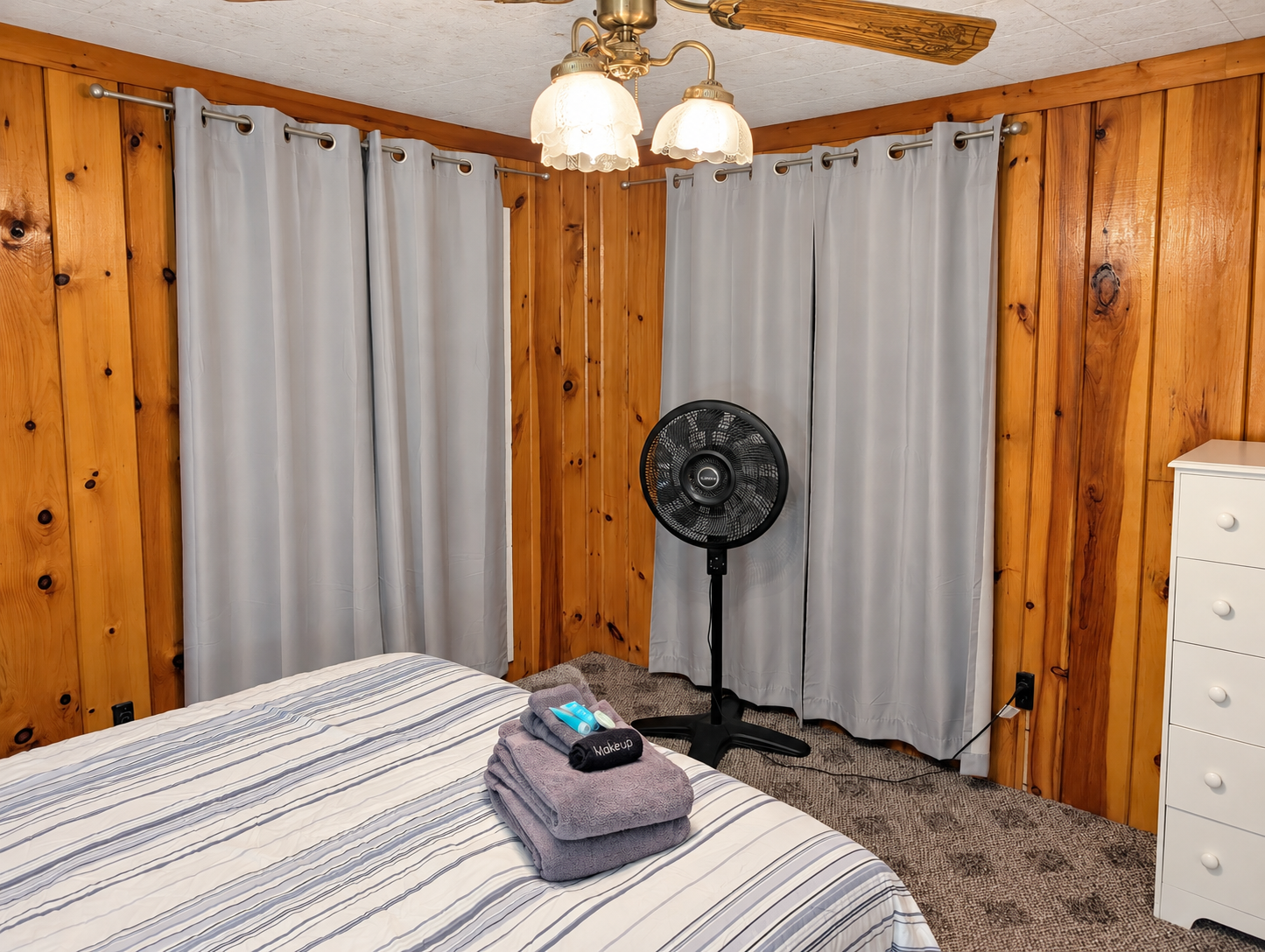 BEDROOM #1:   Features a queen-size bed, nightstands, lamp, dresser, closet, and chair.