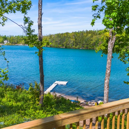 Lake and dock views through the trees from the deck