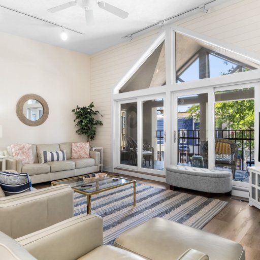 Two sofas under the vaulted ceiling with the balcony beyond.