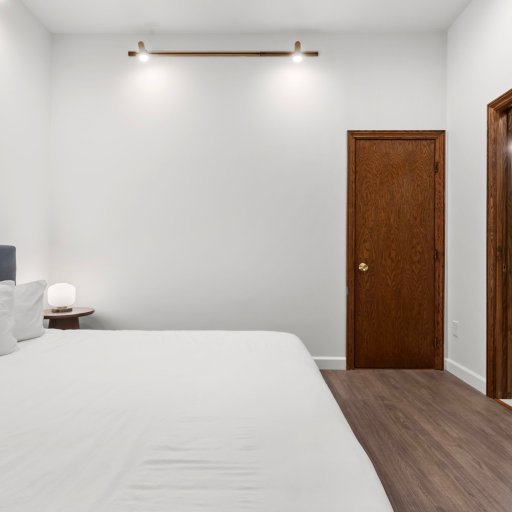 Bedroom 3 with private ensuite — door opens onto a double-vanity bath and walk-in glass shower.